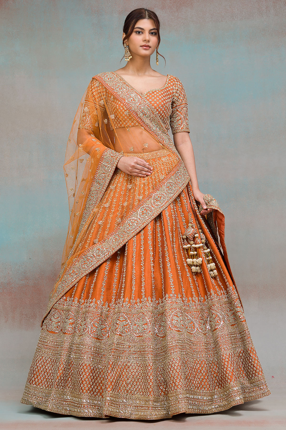 This bride is stunning in this rust orange lehenga by @sabyasachiofficial!  The lehenga is beautifully… | Indian bridal outfits, Indian wedding dress,  Indian dresses
